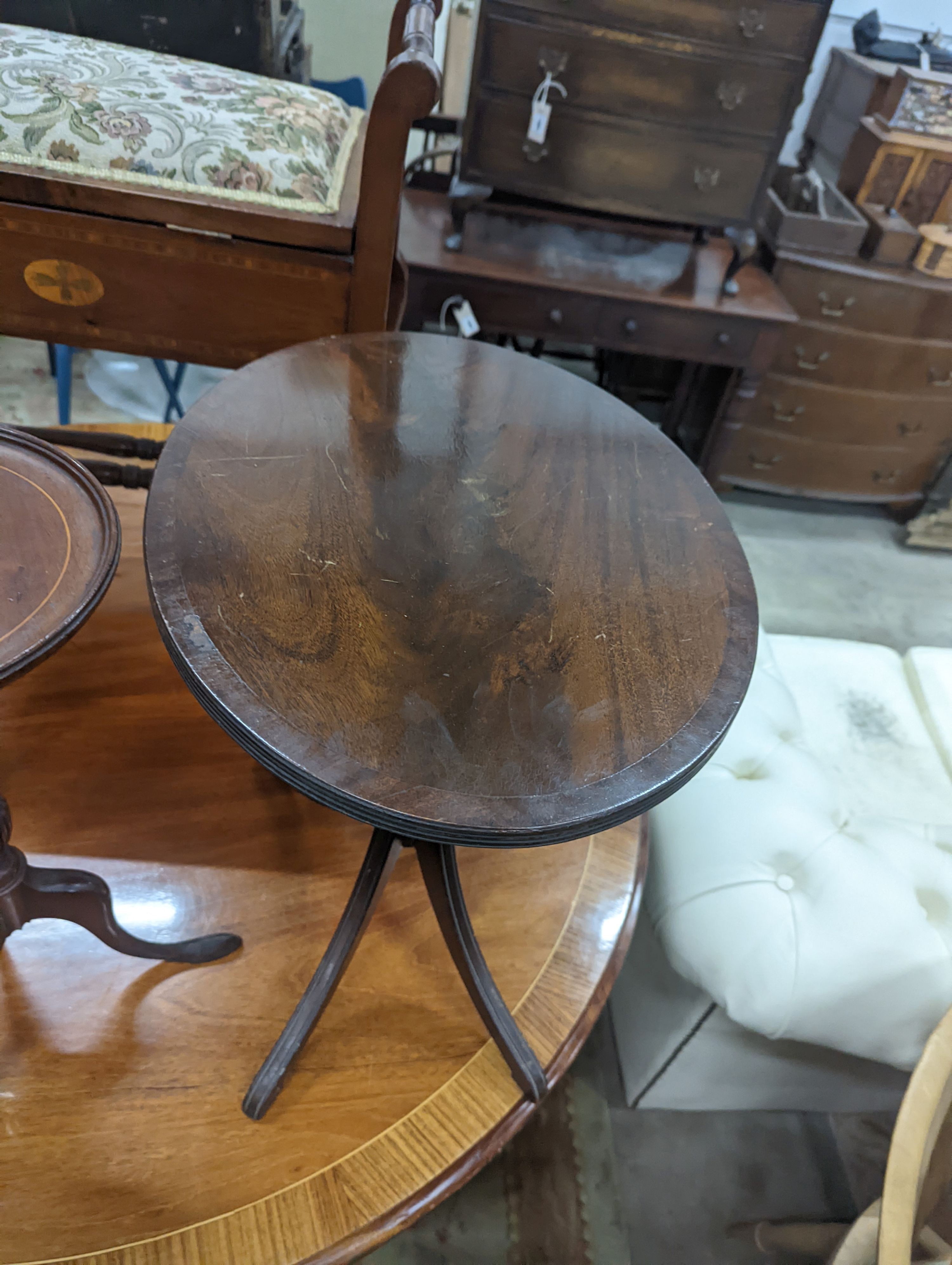 Two Edwardian inlaid mahogany tripod wine tables, larger height 50cm, together with a later folding oval wine table (3)